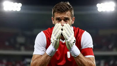 A photorealistic image of an anonymous 35-year-old male football player, wearing a red jersey with white sleeves, and...