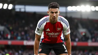 A photorealistic image of an anonymous Arsenal player in a red jersey with white sleeves, black shorts, and white socks...